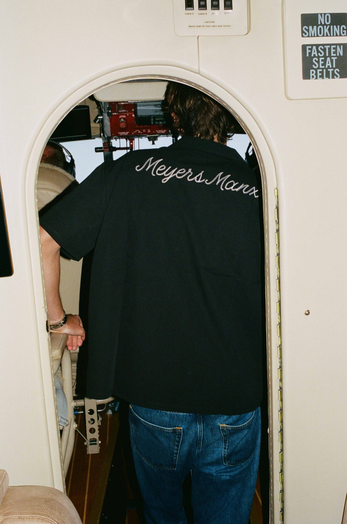 The back of the black Meyers Manx mechanic shirt at the cockpit door