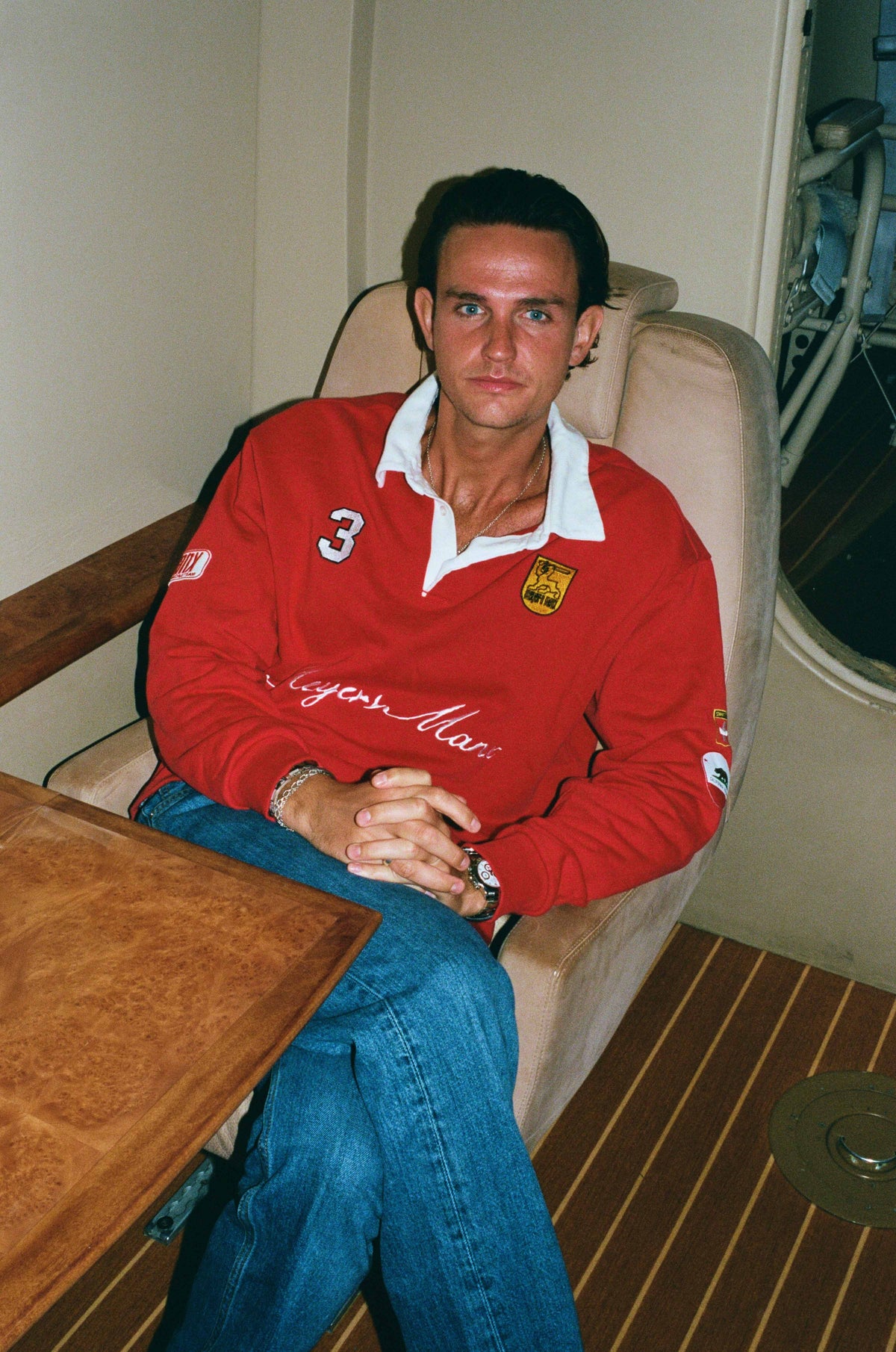 A man in the red rugby relaxing in the cabin