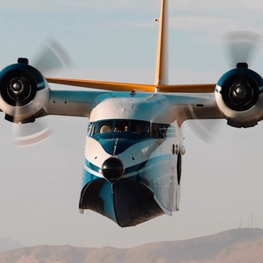 The Albatross head-on in flight, propellers spinning
