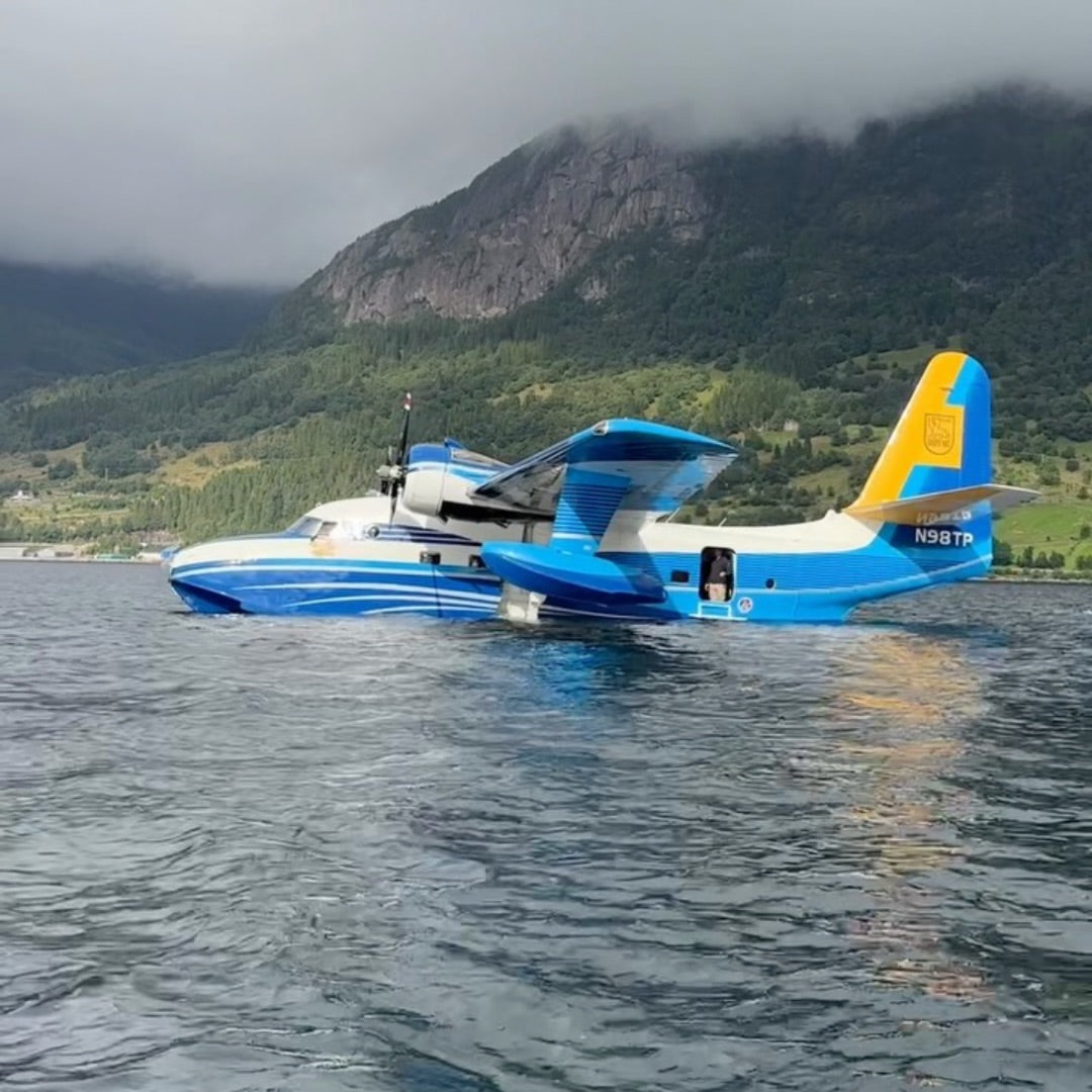 N98TP on the water below green mountains
